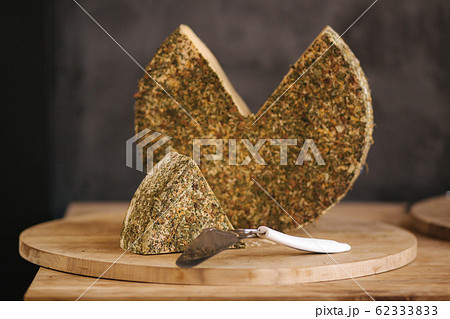 Big piece of lactose-free cheese on wooden board 62333833