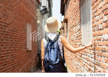 woman walking in the old street at Lukang town 62340099