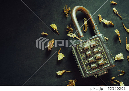 Combination padlock on blackboard background. Top view and copy space. Concept of safety and secret in vintage style. Combination padlock on blackboard background. Top view and copy space. Concept of safety and secret in vintage style. 62340291