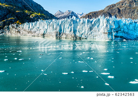 Glacier Bay Alaska cruise vacation travel. Global warming and climate change concept with melting ice. Cruising boat towards landscape of Johns Hopkins Glacier and Mount Fairweather Range mountains 62342563