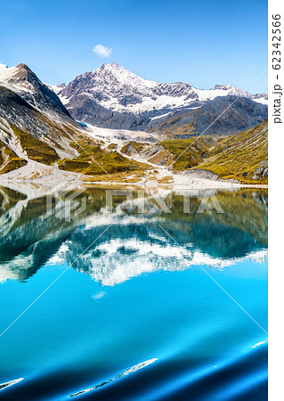 Glacier Bay National Park, Alaska, USA. Amazing glacial landscape view from cruise ship vacation travel showing mountain peaks and glaciers on clear blue sky summer day Glacier Bay National Park, Alaska, USA. Amazing glacial landscape view from cruise ship vacation travel showing mountain peaks and glaciers on clear blue sky summer day 62342566