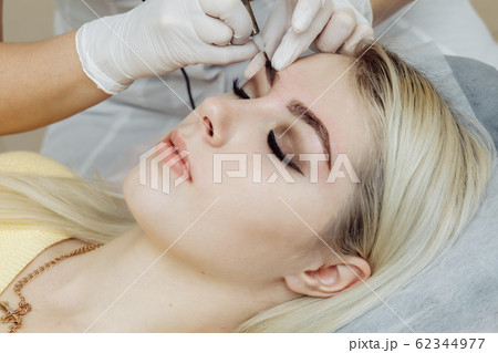 Permanent makeup, tattooing of eyebrows. 62344977