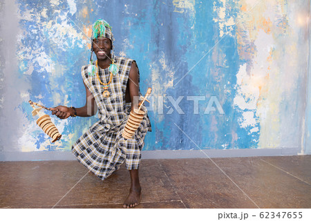 African musician with traditional clothes and musical instruments 62347655