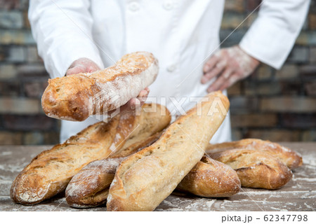 baker with traditional bread french baguettes 62347798