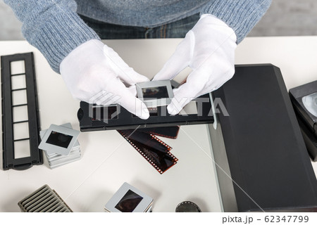 man photographer looking at film slide man photographer looking at film slide 62347799