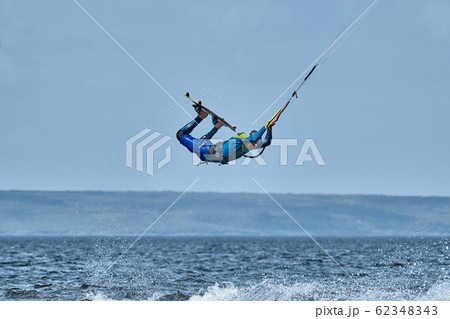 A male kiter slides on the surface of the water. 62348343