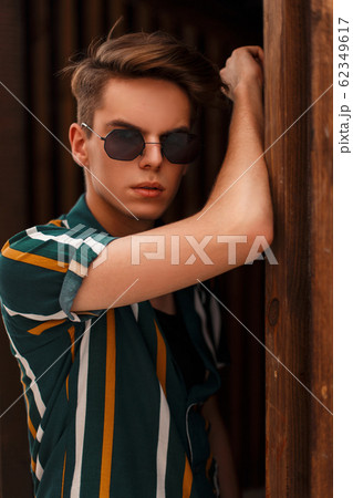 Handsome young stylish man model with hairdo Handsome young stylish man model with hairdo 62349617