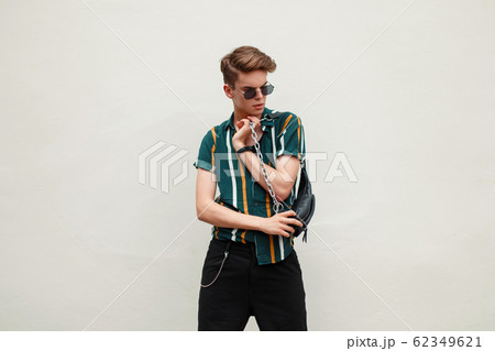 Fashionable handsome young man with sunglasses Fashionable handsome young man with sunglasses 62349621