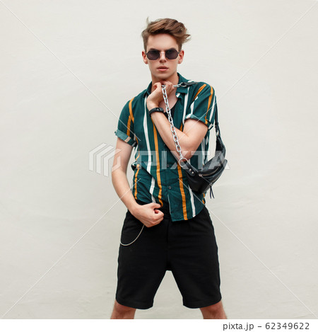 Fashionable handsome young man with sunglasses Fashionable handsome young man with sunglasses 62349622