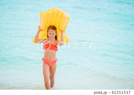 Cute little girl enjoy vacation in the swimming pool Cute little girl enjoy vacation in the swimming pool 62351537