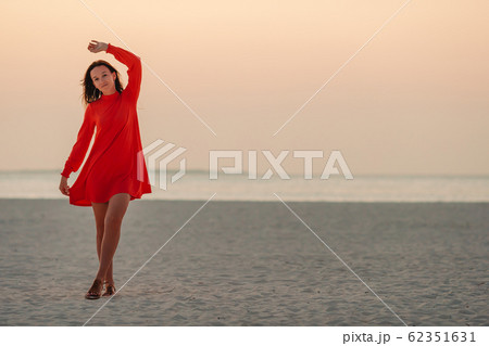 Adorable happy little girl on white beach at sunset. 62351631