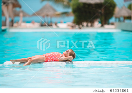 Little adorable girl in outdoor swimming pool Little adorable girl in outdoor swimming pool 62352861