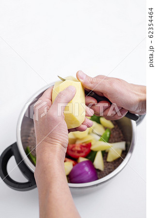 man preparing a vegetarian lentil stew. 62354464