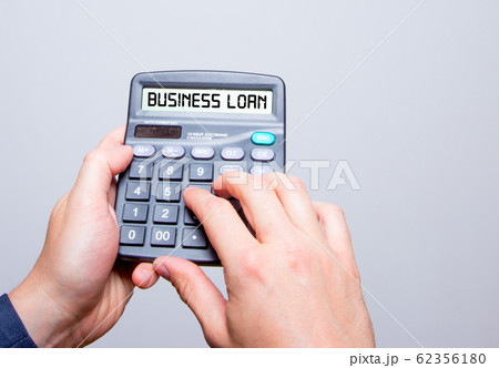 Businessman hands holding Calculator with Business 62356180