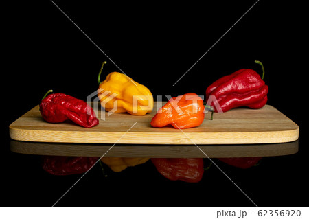 Hot chili pepper isolated on black glass Hot chili pepper isolated on black glass 62356920
