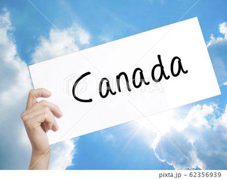 Canada Sign on white paper. Man Hand Holding Paper Canada Sign on white paper. Man Hand Holding Paper 62356939
