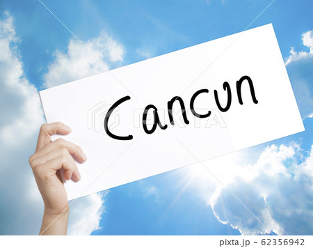 Cancun Sign on white paper. Man Hand Holding Paper 62356942