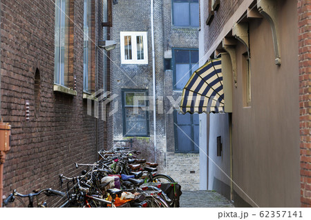 Old small vintage street with bicycles and an Old small vintage street with bicycles and an 62357141