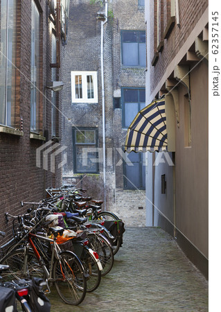 Old small vintage street with bicycles and an Old small vintage street with bicycles and an 62357145