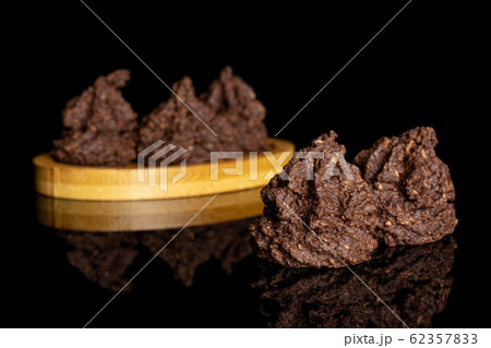 Coconut cocoa biscuit isolated on black glass Coconut cocoa biscuit isolated on black glass 62357833