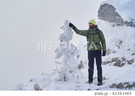 hiker with a walkie-talkie peers into the hiker with a walkie-talkie peers into the 62361465