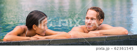 Wellness spa pool couple relaxing in hydrotherapy luxury travel resort on tropical holidays together enjoying the swim in water. Banner panorama. Hotel swimming pool Wellness spa pool couple relaxing in hydrotherapy luxury travel resort on tropical holidays together enjoying the swim in water. Banner panorama. Hotel swimming pool 62361545