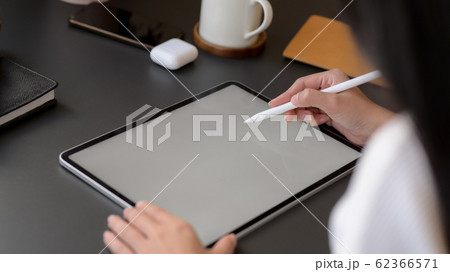 Cropped shot of a woman drawing on mock up tablet 62366571