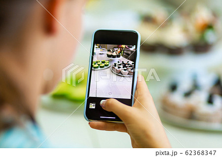 Confectioner girls take pictures of freshly baked Confectioner girls take pictures of freshly baked 62368347