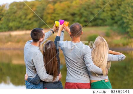 Picnic with friends in at lake near bonfire. Picnic with friends in at lake near bonfire. 62369141