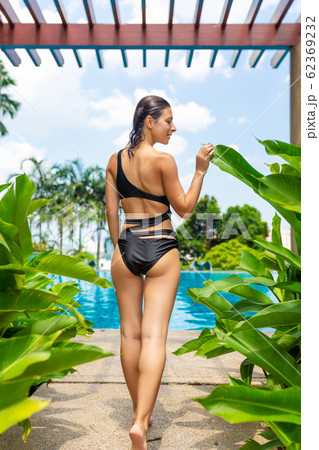 Juicy tropical fruits set at pool edge with 62369232