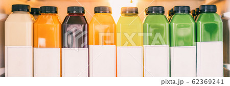 Juice bottles for detox cleanse juicing trend - Healthy diet food delivery at home in fridge banner panorama. Selection of cold press vegetable and fruit juices, orange, lemon, beets, spinach Juice bottles for detox cleanse juicing trend - Healthy diet food delivery at home in fridge banner panorama. Selection of cold press vegetable and fruit juices, orange, lemon, beets, spinach 62369241