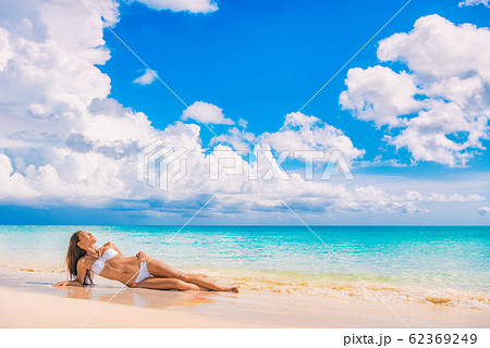 Toned Abs Sexy Slim Stomach Bikini Body Woman On Beach Vacation Background  For Weight Loss And Fat Treatment Concept. Happy Asian Girl Swimsuit Model  Feeling Good Showing Off Waist And Arms Up.