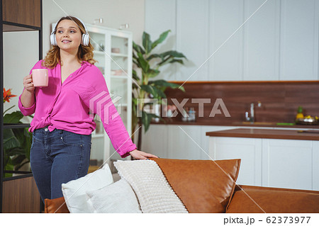 Delighted female person going to drink tea Delighted female person going to drink tea 62373977