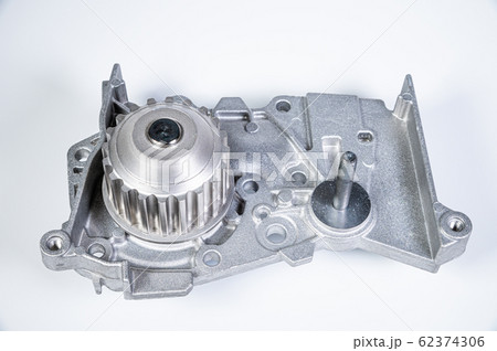 New metal automobile pump for cooling the engine of a water pump on a gray background. The concept of new spare parts for the car engine New metal automobile pump for cooling the engine of a water pump on a gray background. The concept of new spare parts for the car engine 62374306