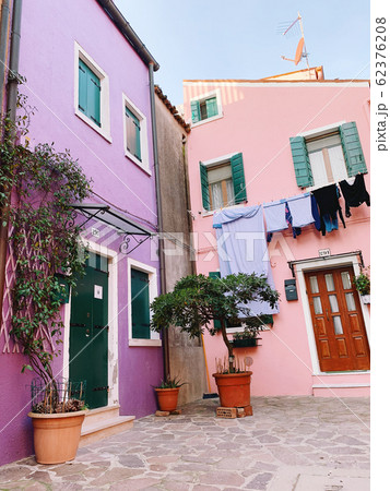 BURANO, ITALY - JANUARY 20, 2020: Colorful houses on the island of Burano in Italy. Burano island is famous for its colorful fisherman's houses. BURANO, ITALY - JANUARY 20, 2020: Colorful houses on the island of Burano in Italy. Burano island is famous for its colorful fisherman's houses. 62376208