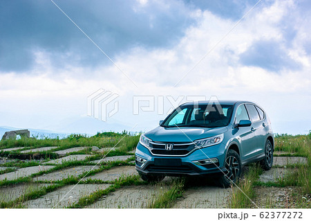 blue suv on a paved meadow 62377272