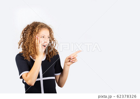 Shocked young girl pointing Shocked young girl pointing 62378326