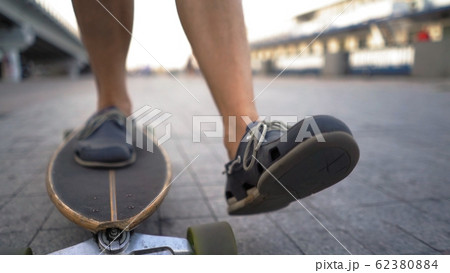 Light-Skinned Mid-Aged Man Gaining Speed On Skateboard Ahead Outdoor. 62380884
