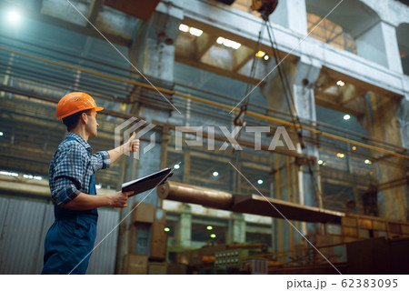 Master shows thumbs up to crane operator, factory Master shows thumbs up to crane operator, factory 62383095