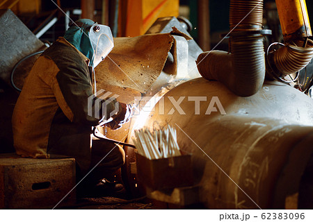 Welder in mask works with metal construction Welder in mask works with metal construction 62383096