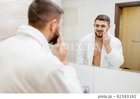 Man applies shaving foam, morning hygiene 62383162