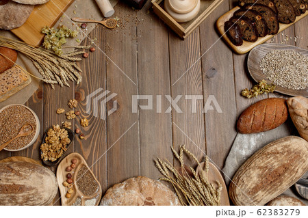 Whole grain multigrain bread, whole and sliced, contains seeds isolated on black 62383279