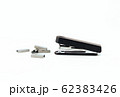 Black stapler and metal staple isolated on a white 62383426