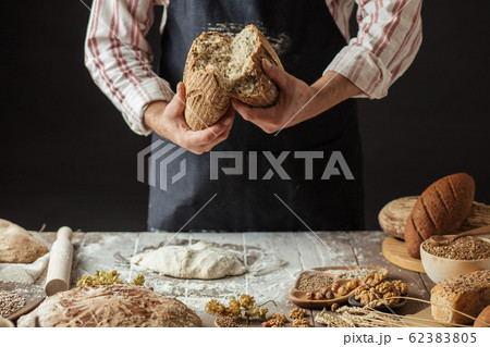 Chef Breaking Freshly Baked Sourdough Bread Chef Breaking Freshly Baked Sourdough Bread 62383805