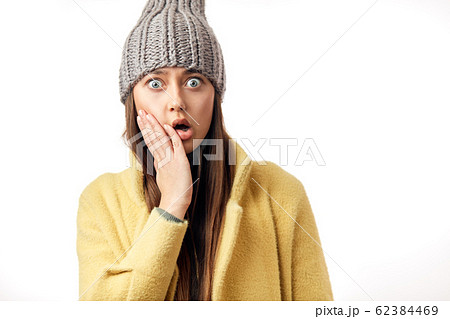 Surprised positive girl showing palms staring isolated over white background 62384469