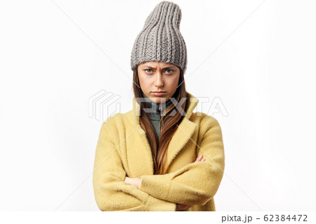 Confused and offended caucasian woman in colorful winter clothes posing indoors 62384472