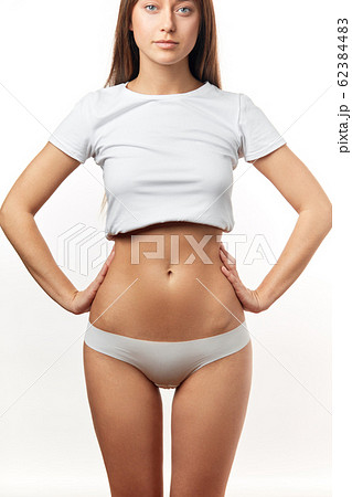 Beautiful woman in underwear testing fat layer on waist. Stock Photo by  ©ufabizphoto 269871436