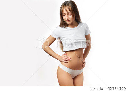 Beautiful woman in underwear testing fat layer on waist. Stock Photo by  ©ufabizphoto 235225360