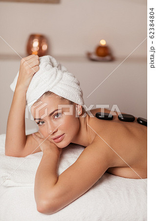 attractive girl with a towel on her head looking at the camera attractive girl with a towel on her head looking at the camera 62384804