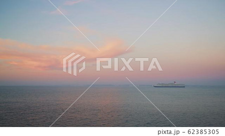 Gimbal shot of a cruise ship on background of sunset and horizon Gimbal shot of a cruise ship on background of sunset and horizon 62385305